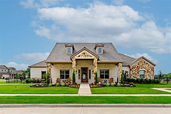 a front view of a house with a garden