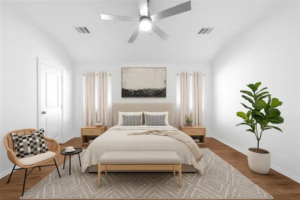 a bedroom with a bed table and chair