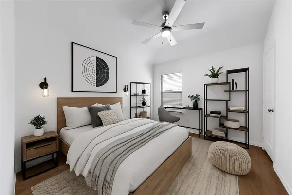 a spacious bedroom with a bed and a chandelier