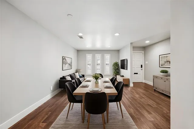 a view of a dining room with furniture and wooden floor