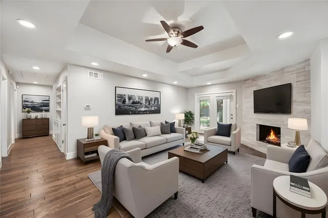 a living room with furniture kitchen view and a fireplace