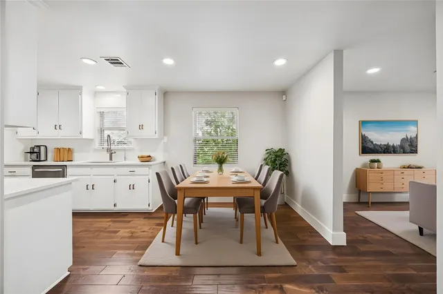 a view of kitchen with cabinets table and chairs