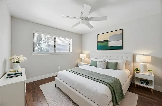 a bedroom with a bed and ceiling fan