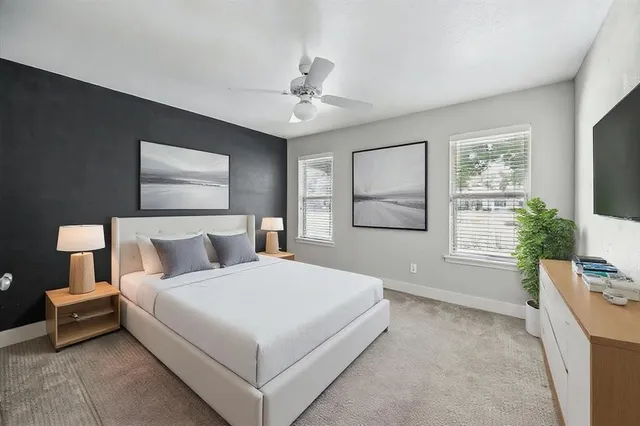 a bedroom with a large bed and a window