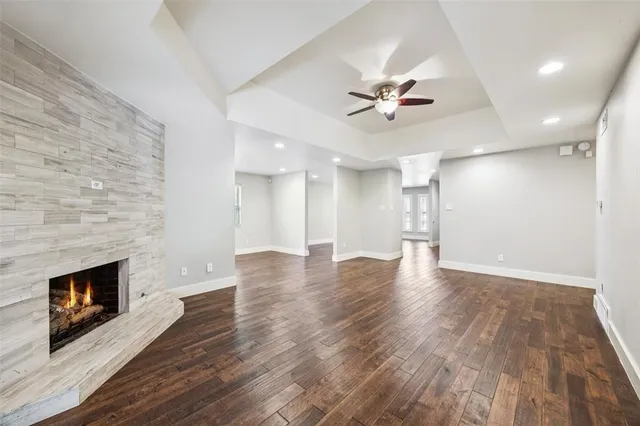 wooden floor in an empty room with a fireplace