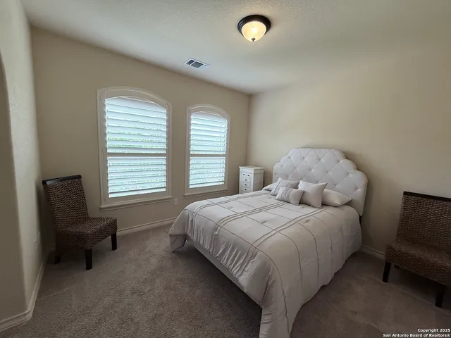 a bedroom with a bed and a chair