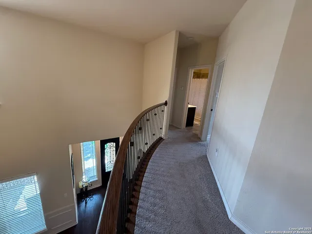 a view of a hallway with wooden floor and entryway