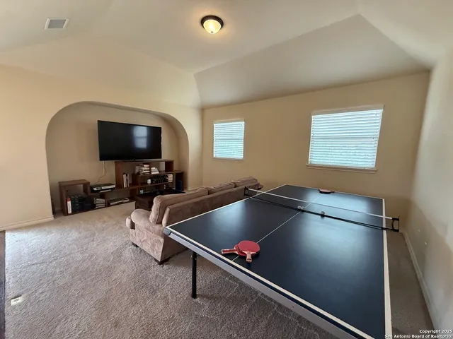 a room with gym equipment and a flat screen tv