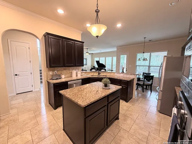 a kitchen with a counter space appliances and cabinets