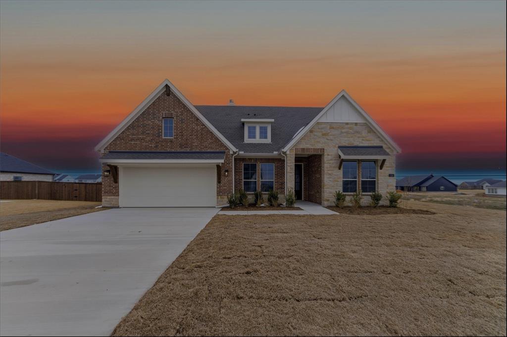 114 Brandywine Trail Rhome, TX 76078 - Photo 2 of 27 a front view of a house with a yard and garage