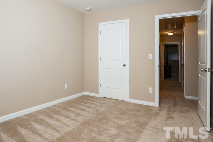 3517 Midway Island Court Raleigh, NC 27610 - Photo 4 of 9 an empty room with closet and a bathroom