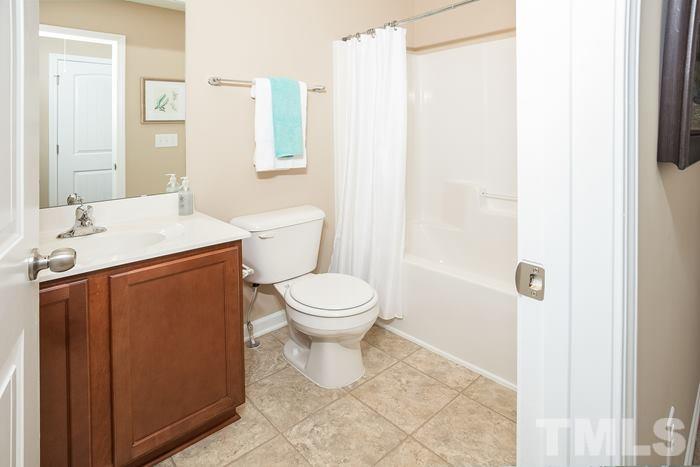3517 Midway Island Court Raleigh, NC 27610 - Photo 5 of 9 a bathroom with a toilet sink and a mirror