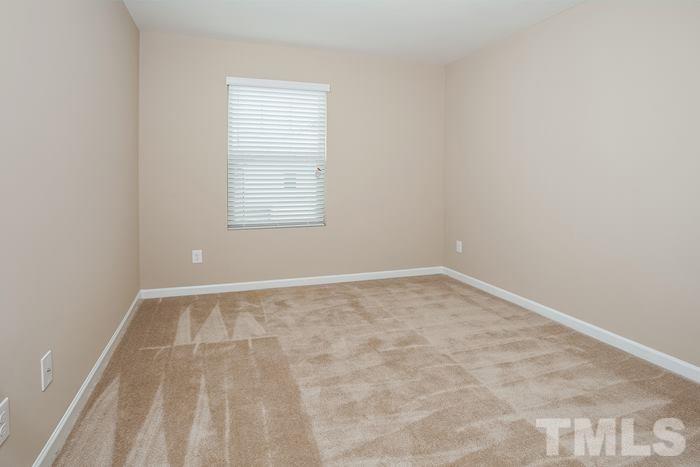 3517 Midway Island Court Raleigh, NC 27610 - Photo 6 of 9 an empty room with a white walls and a window
