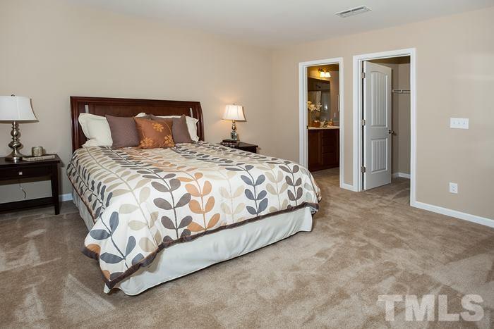 3517 Midway Island Court Raleigh, NC 27610 - Photo 8 of 9 a bedroom with a bed and closet