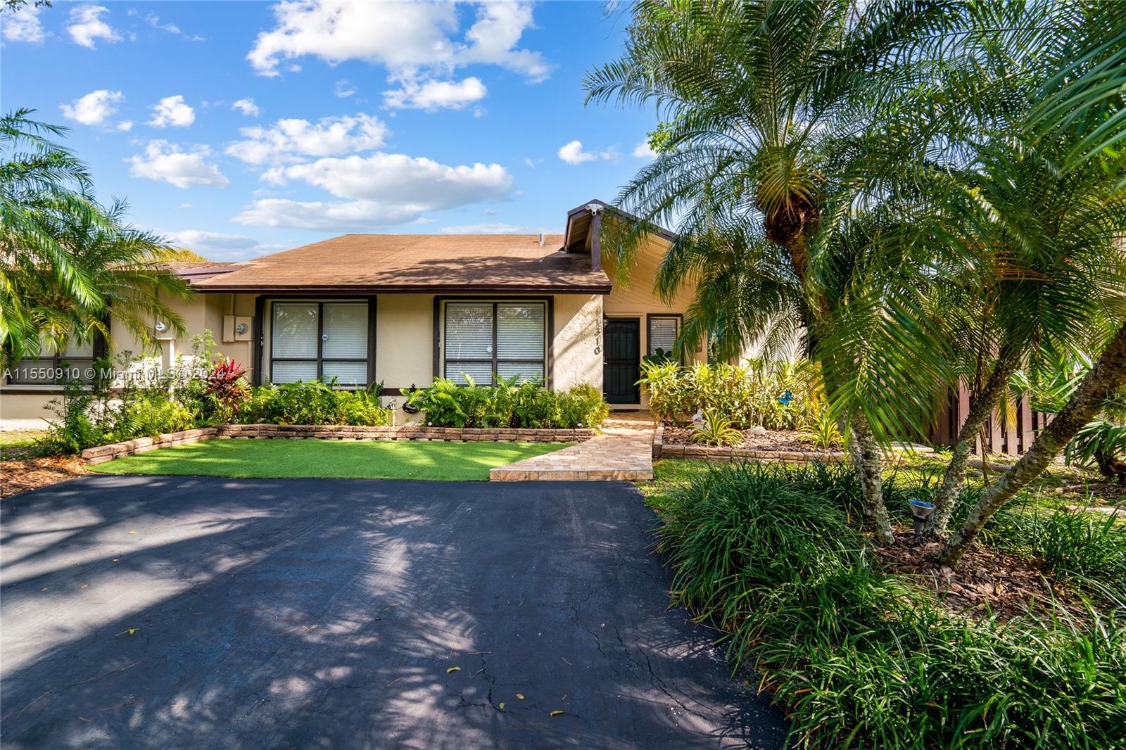 11310 Southwest 115th Terrace, Unit 11310 Miami, FL 33176 - Photo 1 of 13 a front view of a house with garden