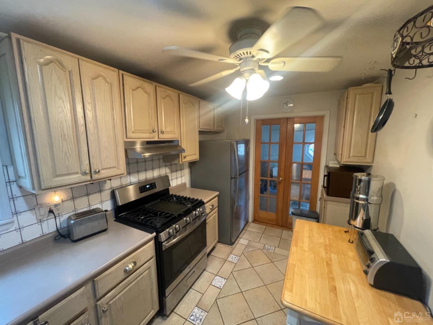 22 Wilcox Road New Brunswick, NJ 08901 - Photo 8 of 12 a kitchen with a stove a sink and cabinets