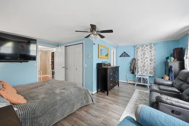 a bedroom with furniture and a flat screen tv