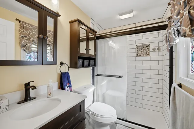 a bathroom with a sink toilet and shower