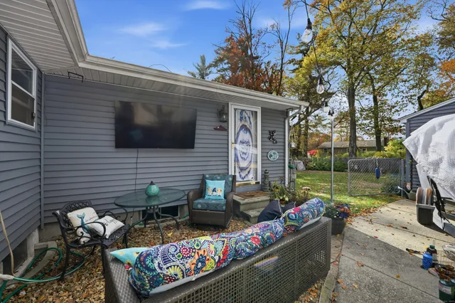 a view of a patio with couches chairs and a fire pit