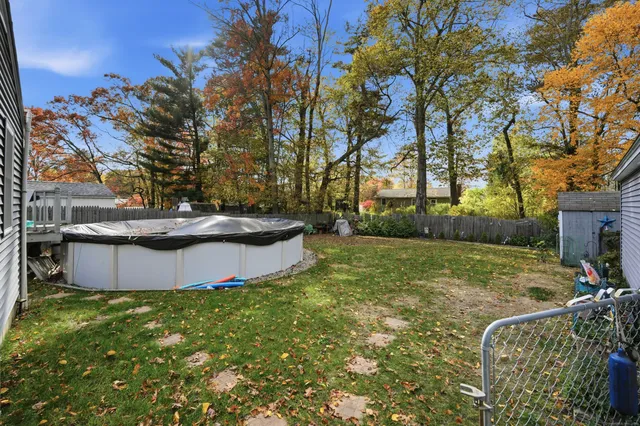 a view of a backyard with large trees