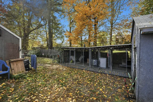 a backyard of a house with barbeque oven table and chairs