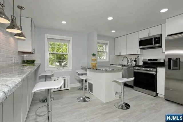 a kitchen with a sink cabinets and window