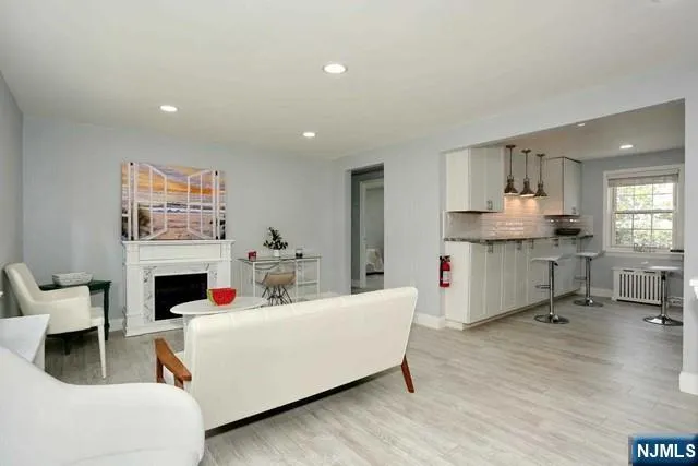 a living room with furniture and a fireplace