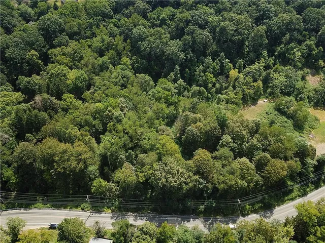 an aerial view of residential house with outdoor space and swimming pool