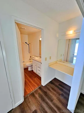 a view of a hallway and a livingroom with wooden floor