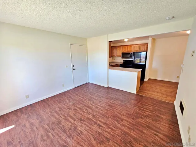 a view of a kitchen with a sink and a refrigerator