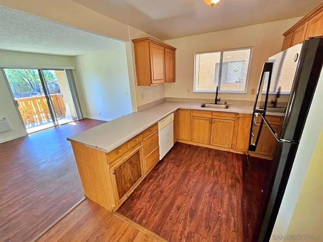 a kitchen with wooden floors and a sink