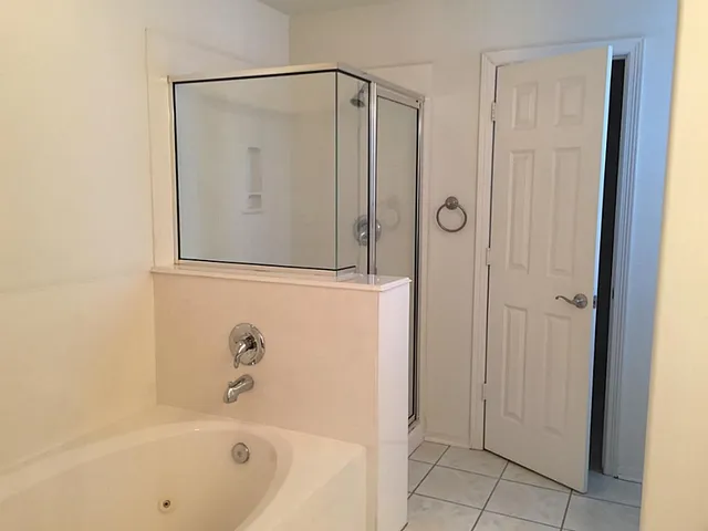 a bathroom with a bathtub and a shower