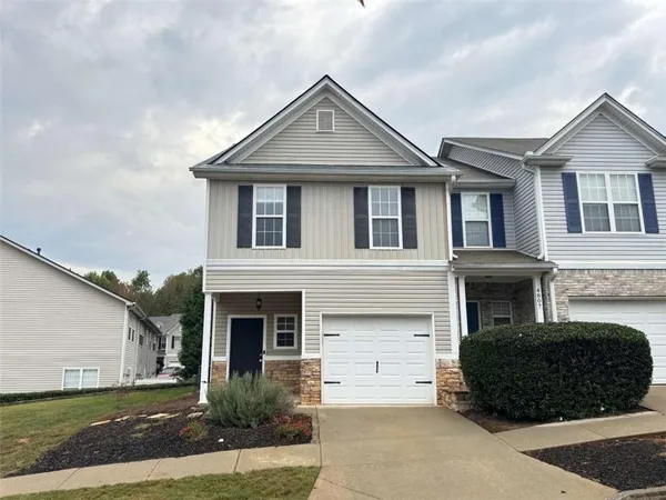 a front view of a house with a yard