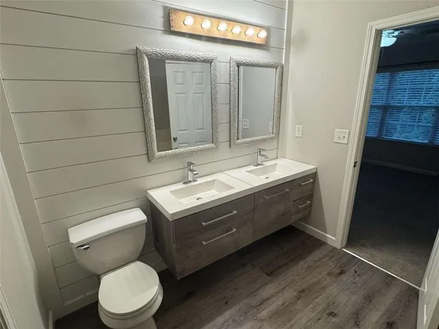 a bathroom with a toilet sink and mirror