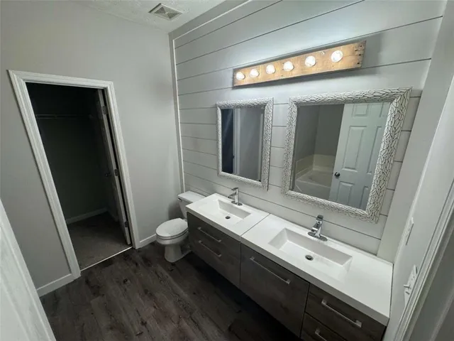a bathroom with a double vanity sink and mirror