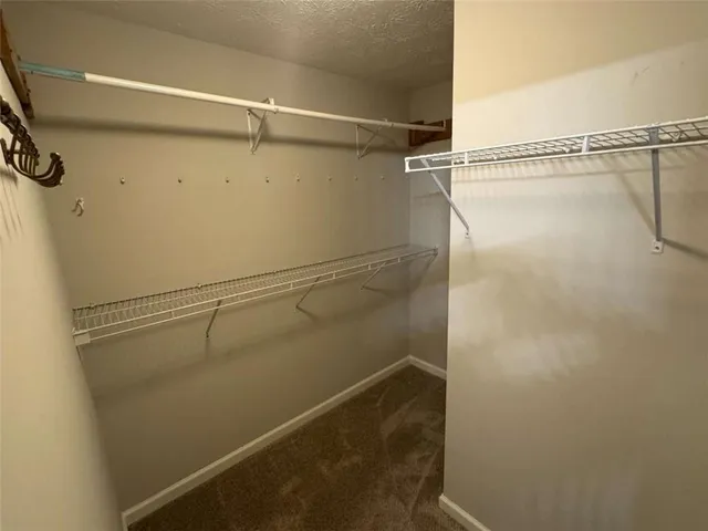 en empty room with a window and a fan