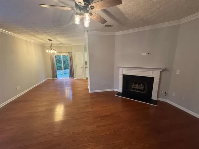an empty room with windows and fireplace