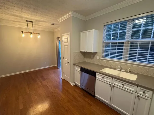 a kitchen with granite countertop a sink and a stove