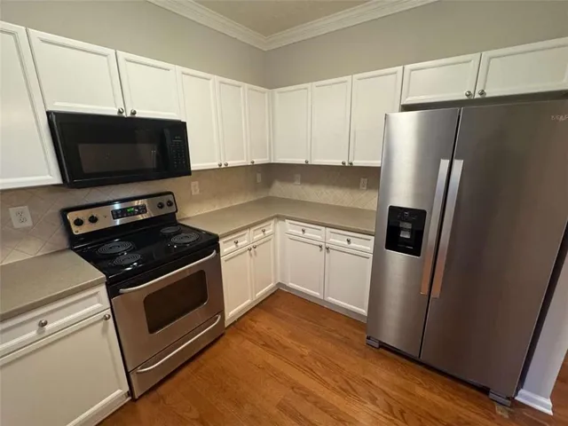 a kitchen with a refrigerator stove and microwave
