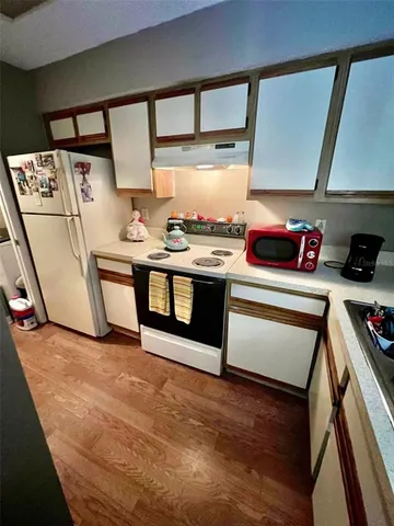 a kitchen with stainless steel appliances granite countertop a sink and cabinets