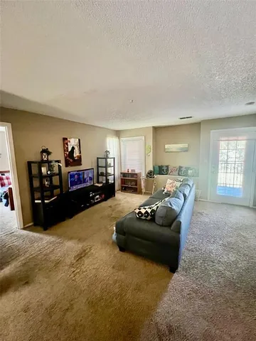 a bedroom with a bed and a chair