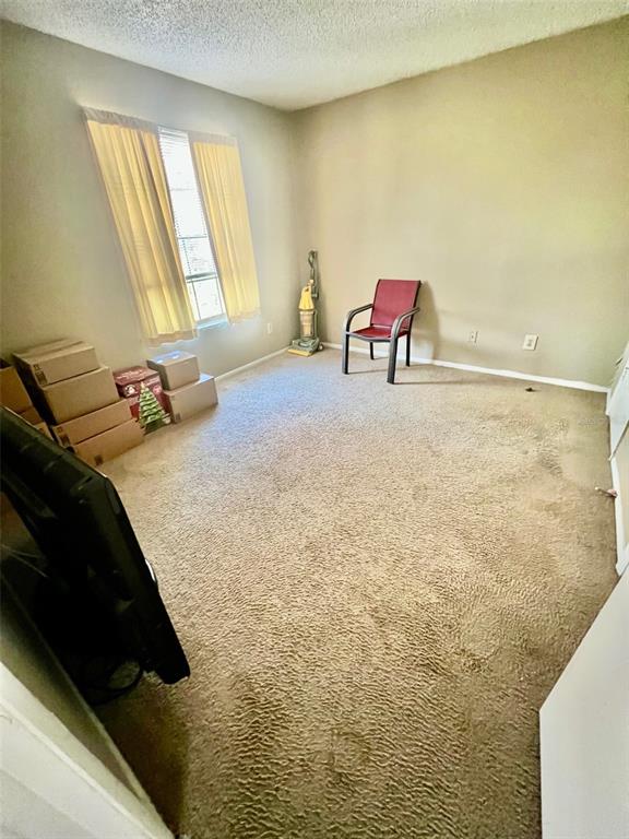 224 Afton Square, Unit 202 Altamonte Springs, FL 32714 - Photo 8 of 13 a bedroom with a bed and a chair