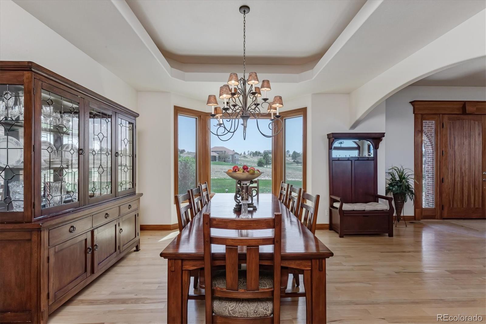 12080 Summit Ridge Road Parker, CO 80138 - Photo 11 of 39 a view of a dining room with furniture window and wooden floor