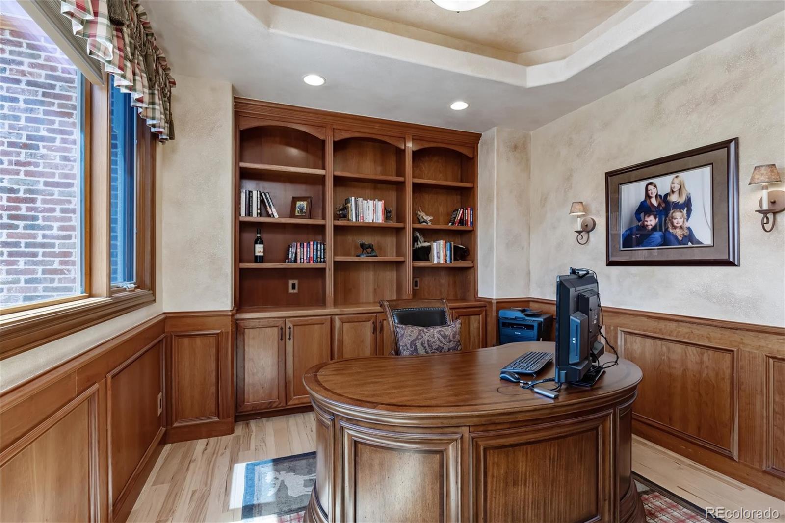 12080 Summit Ridge Road Parker, CO 80138 - Photo 12 of 39 a kitchen with stainless steel appliances granite countertop a table chairs and a refrigerator