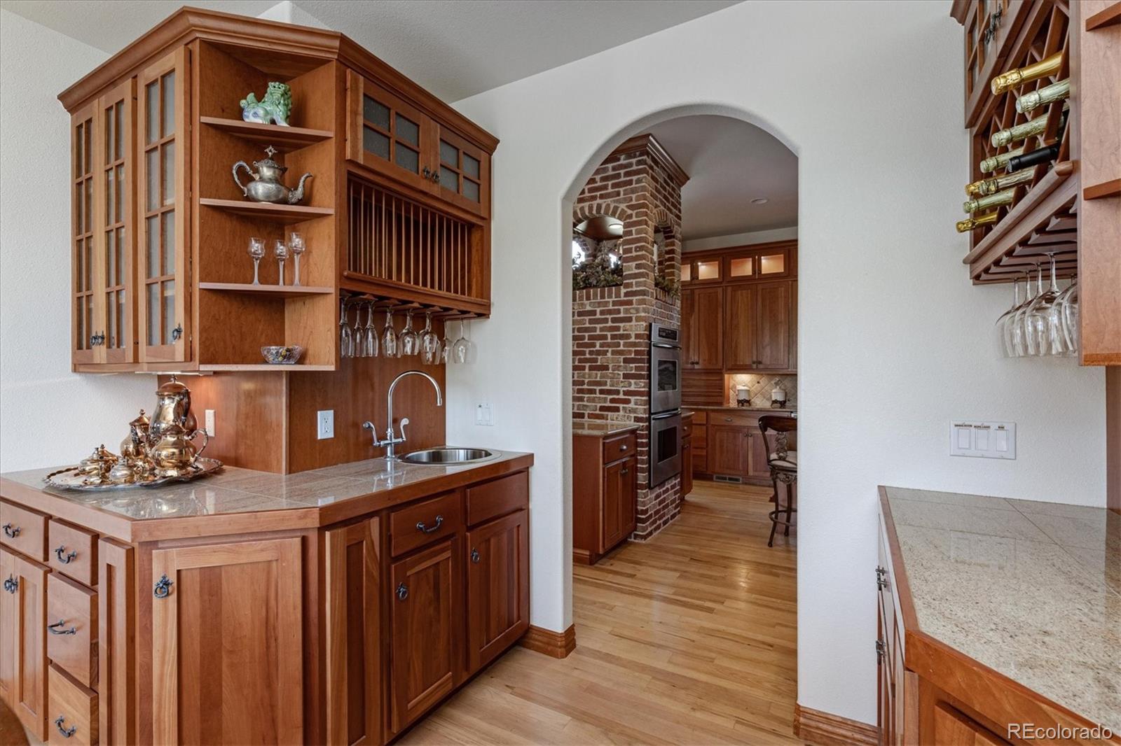 12080 Summit Ridge Road Parker, CO 80138 - Photo 13 of 39 a kitchen view of a kitchen island wooden floor and stainless steel appliances