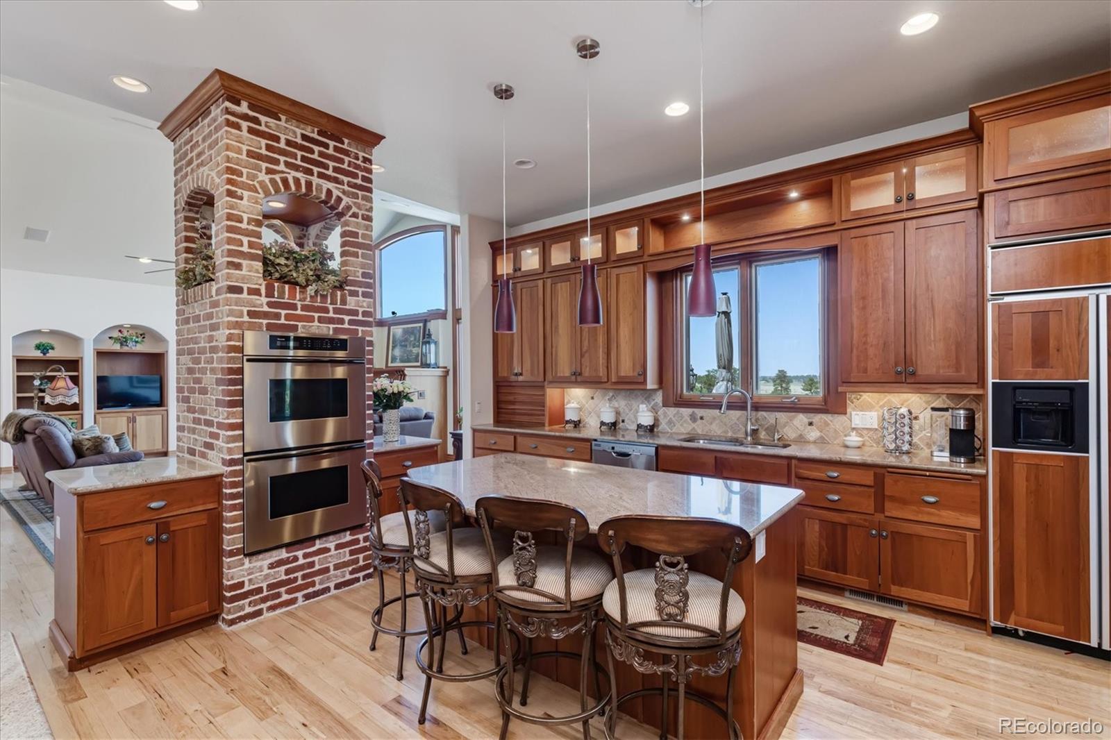 12080 Summit Ridge Road Parker, CO 80138 - Photo 17 of 39 a large kitchen with a table and chairs in it