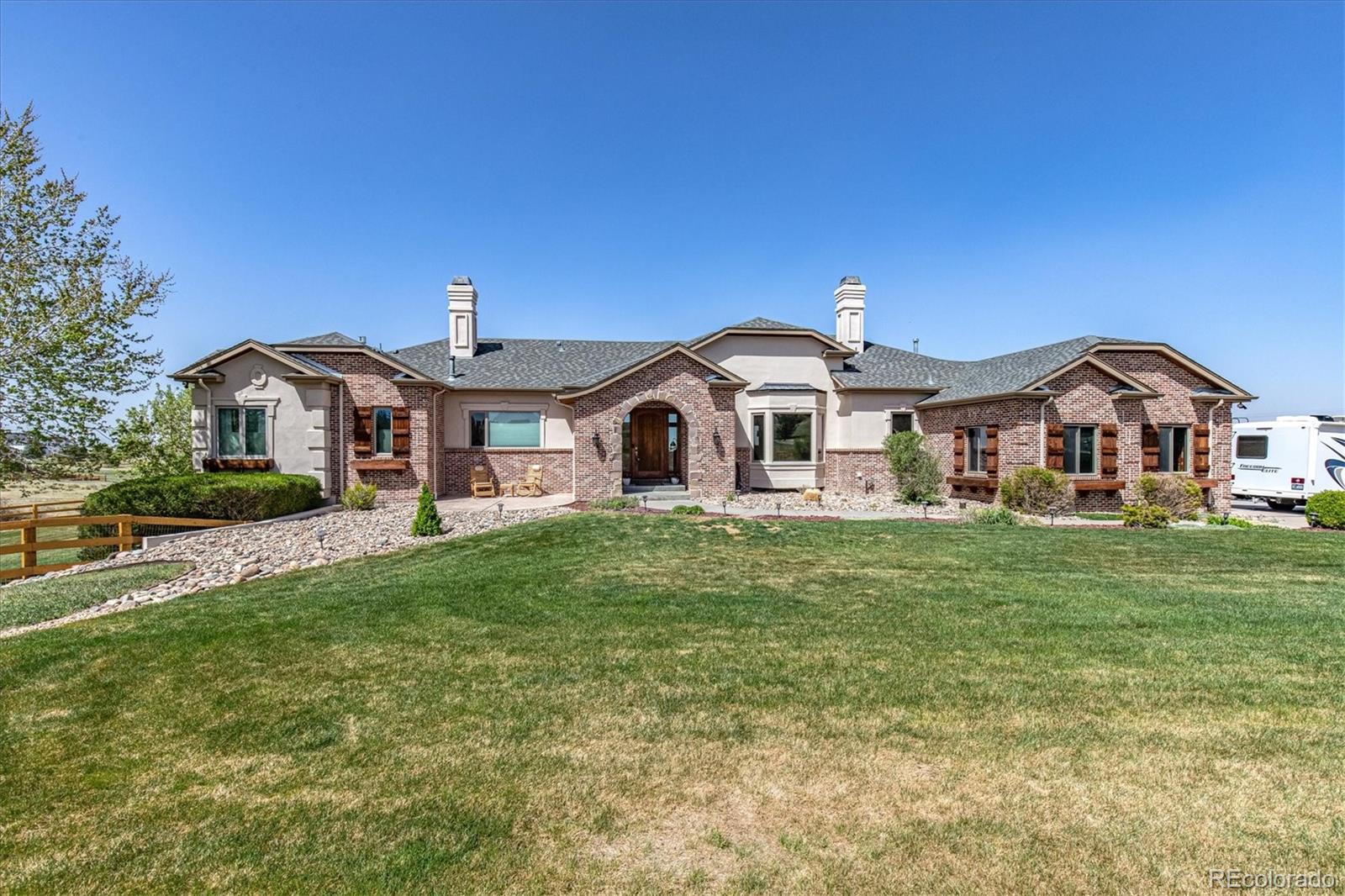 12080 Summit Ridge Road Parker, CO 80138 - Photo 2 of 39 a front view of a house with a yard
