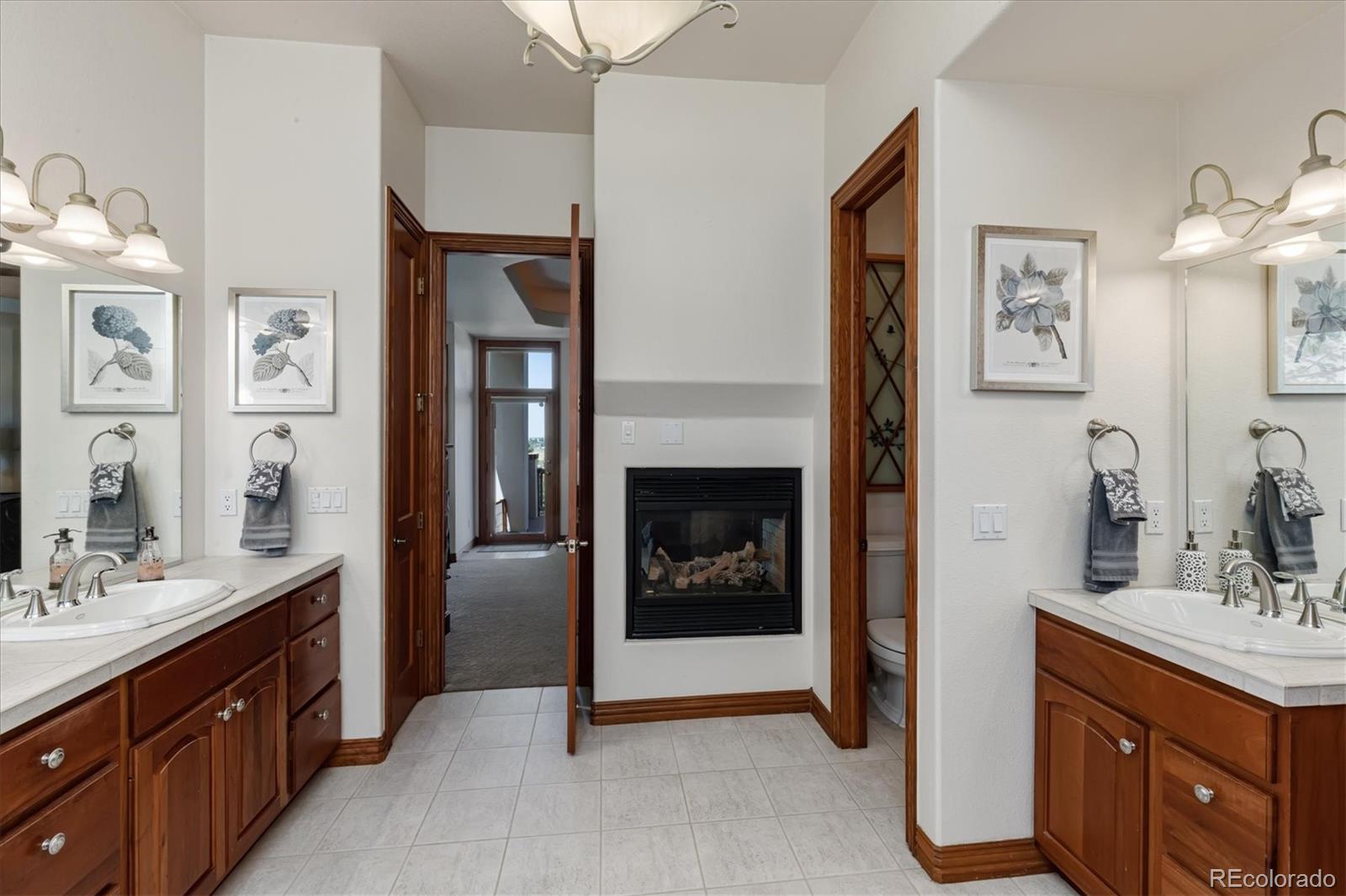 12080 Summit Ridge Road Parker, CO 80138 - Photo 24 of 39 a spacious bathroom with a double vanity sink double and a mirror