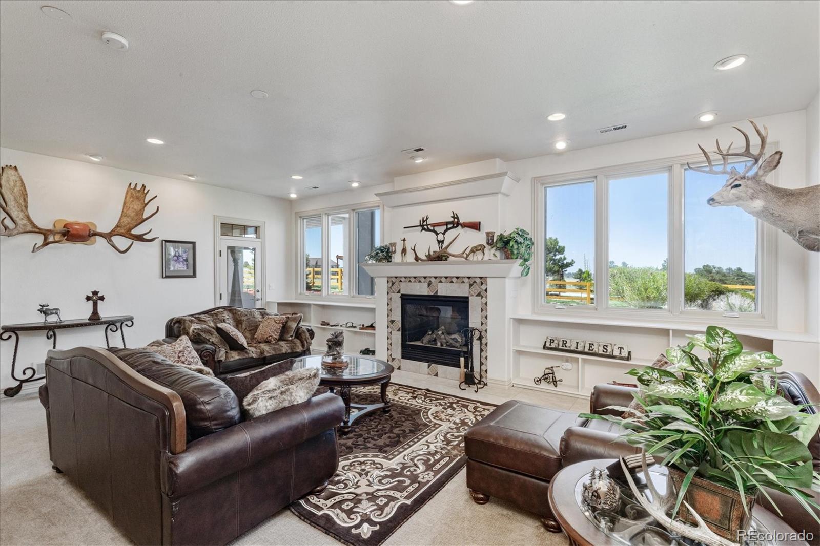 12080 Summit Ridge Road Parker, CO 80138 - Photo 26 of 39 a living room with furniture and a fireplace