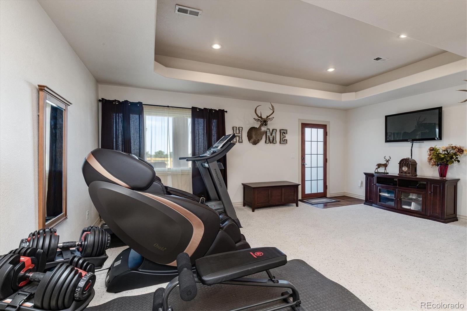 12080 Summit Ridge Road Parker, CO 80138 - Photo 27 of 39 a room with furniture and a flat screen tv